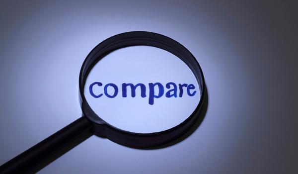 a picture of a magnifying glass focusing on the word "compare" to emphasize the importance of researching and comparing products.