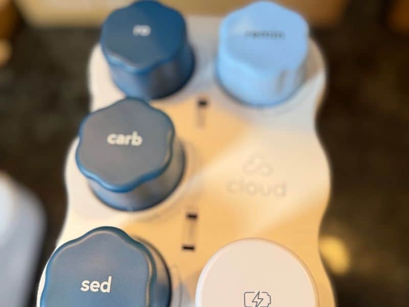 Cloud RO with its cover removed, showing the sediment, carbon, membrane, and mineral cartridges beside the battery pack